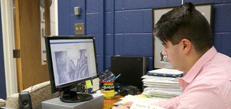 A Chase Collegiate student works on the computer in his Media & Tech class.